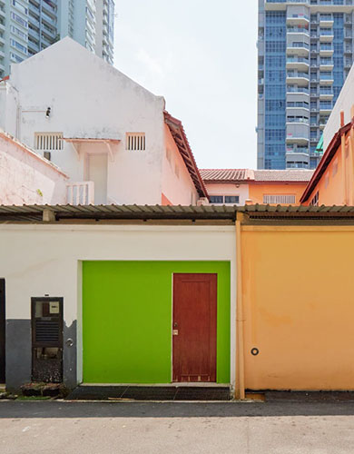 A vibrant building featuring two doors, one of which is a striking green door.